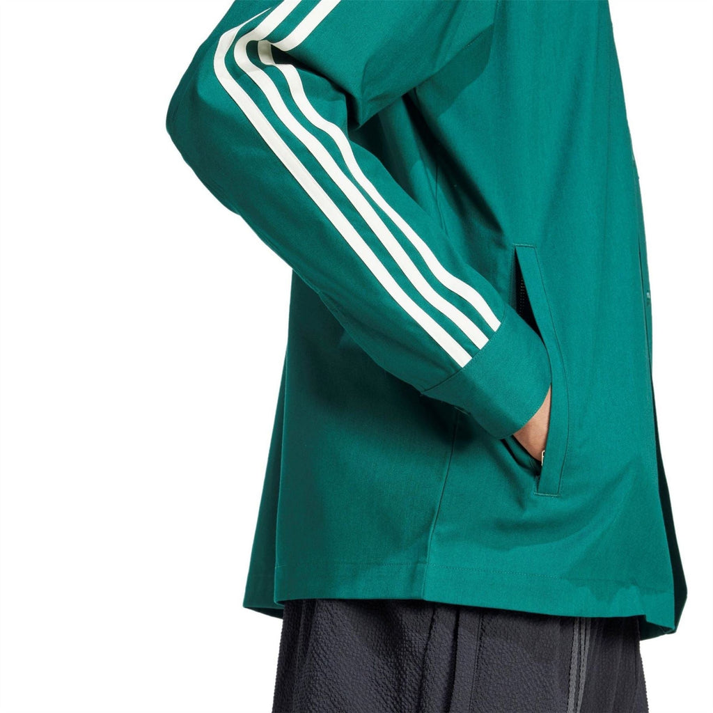 Green jacket with white triple stripe sleeve detail and buttoned front placket