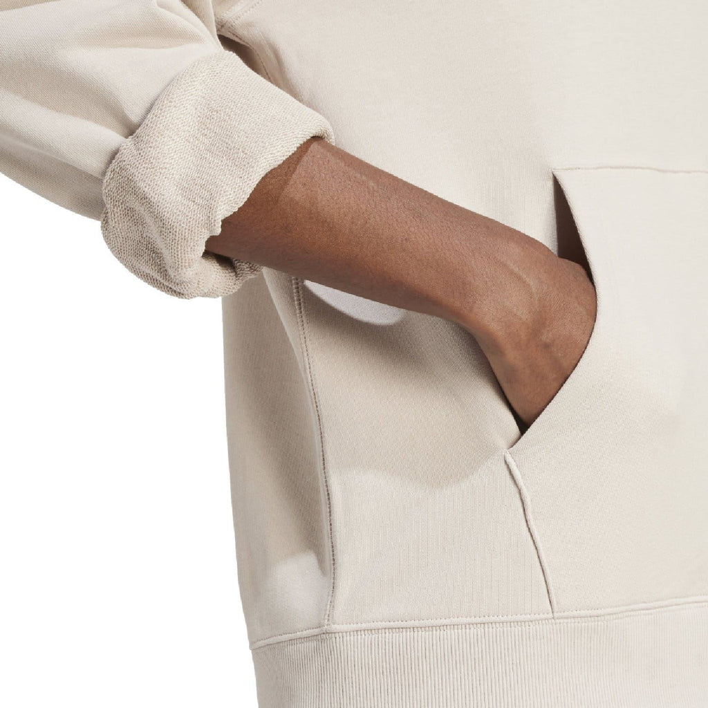 Beige hoodie sleeve and kangaroo pocket seam detail