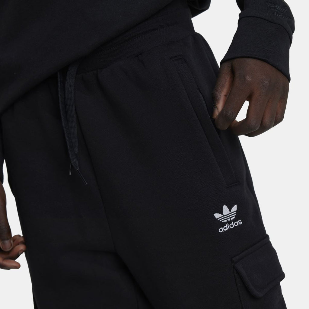 Black fleece cargo pants with adidas logo and side cargo pocket, adjustable drawstring waist