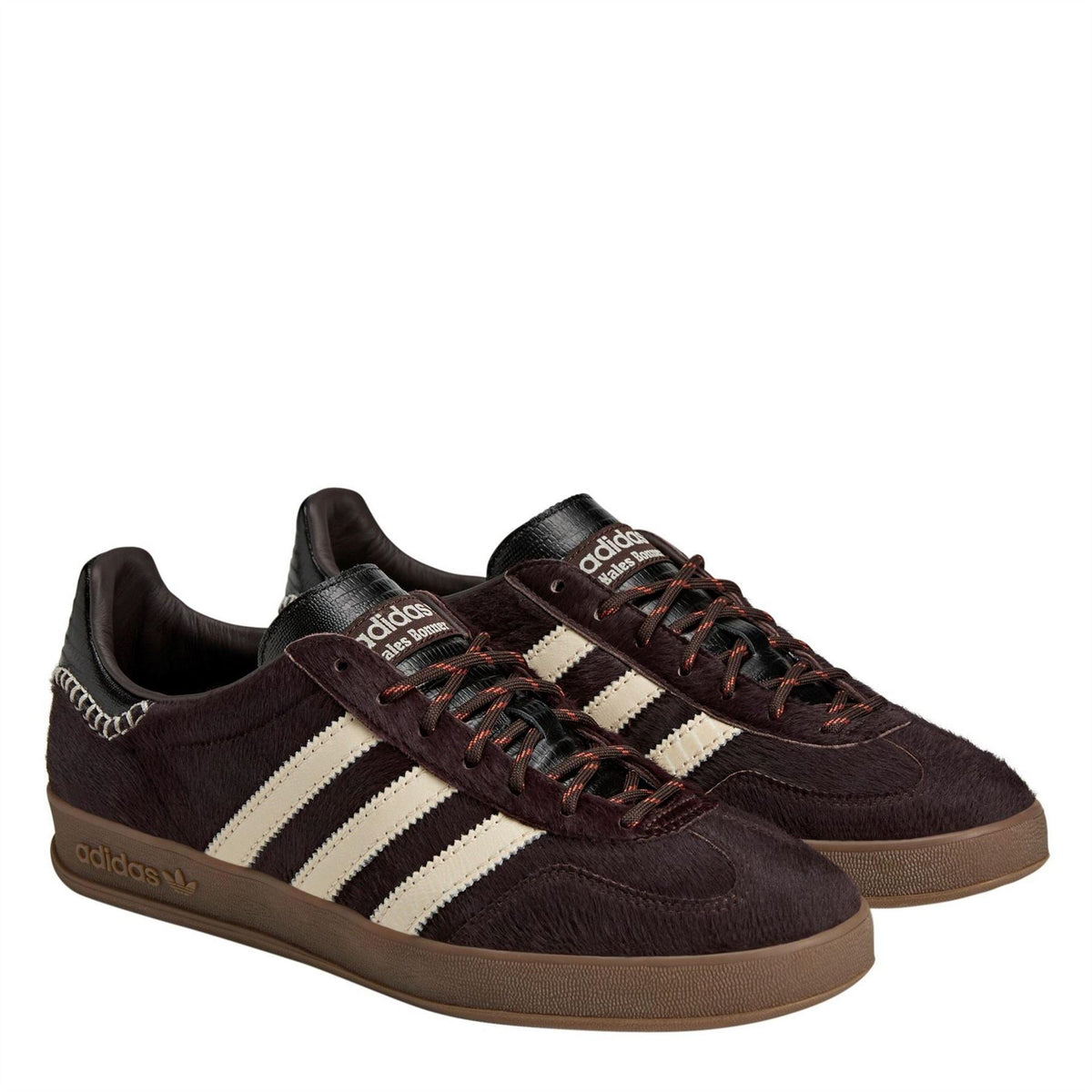 Dark brown pony Gazelle shoes with white stripes, braided collar trim, lace-up, gum sole.