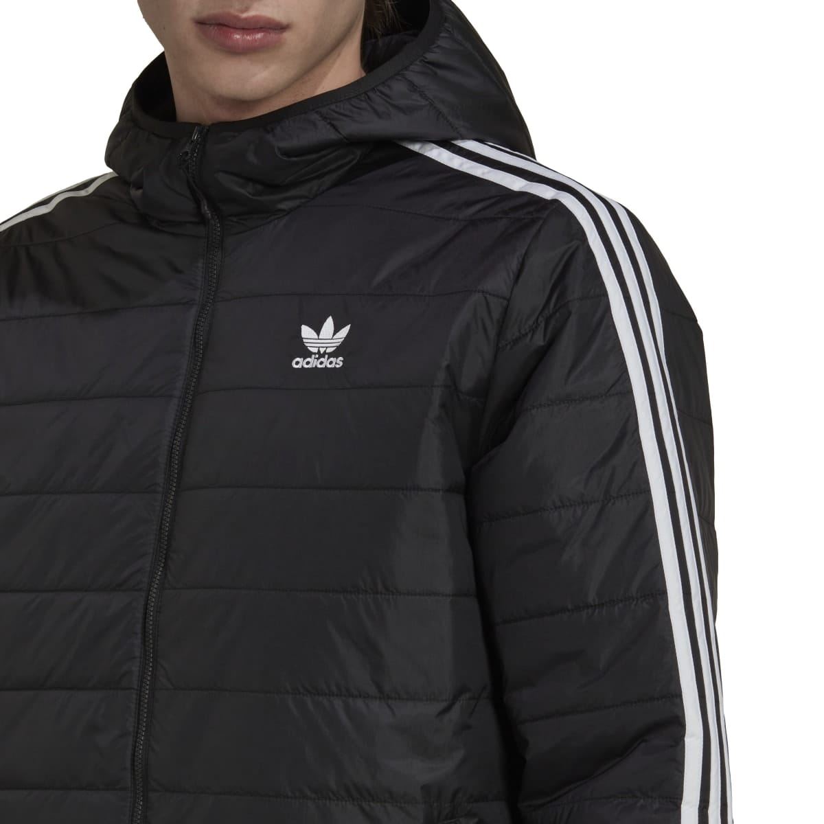 Black hooded padded coat close-up showing adidas logo and white 3-stripe shoulder sleeve.