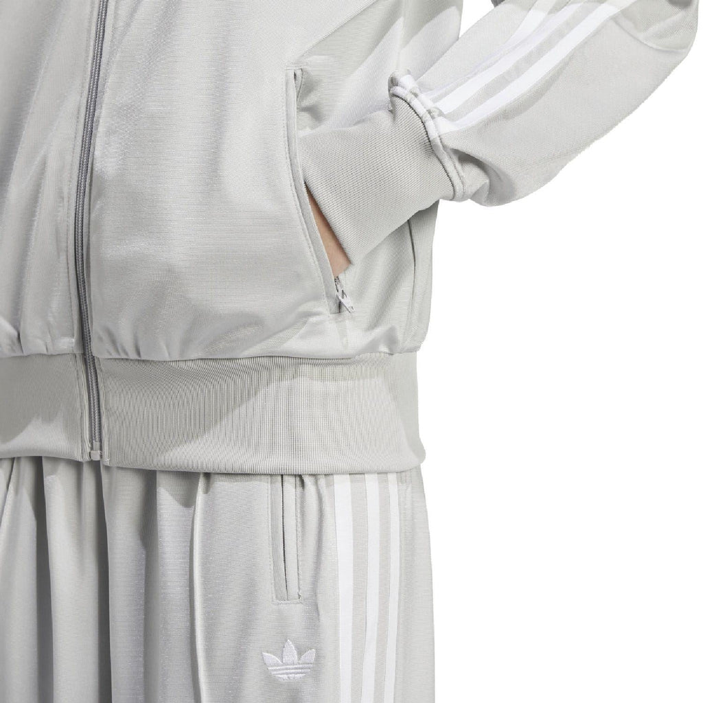 Light grey track jacket hem and cuffs with ribbed texture and trefoil badge
