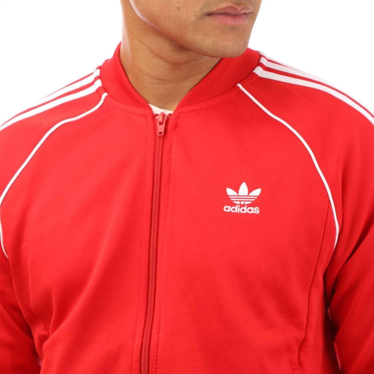 Red track jacket with adidas logo on chest and white trim zip collar.