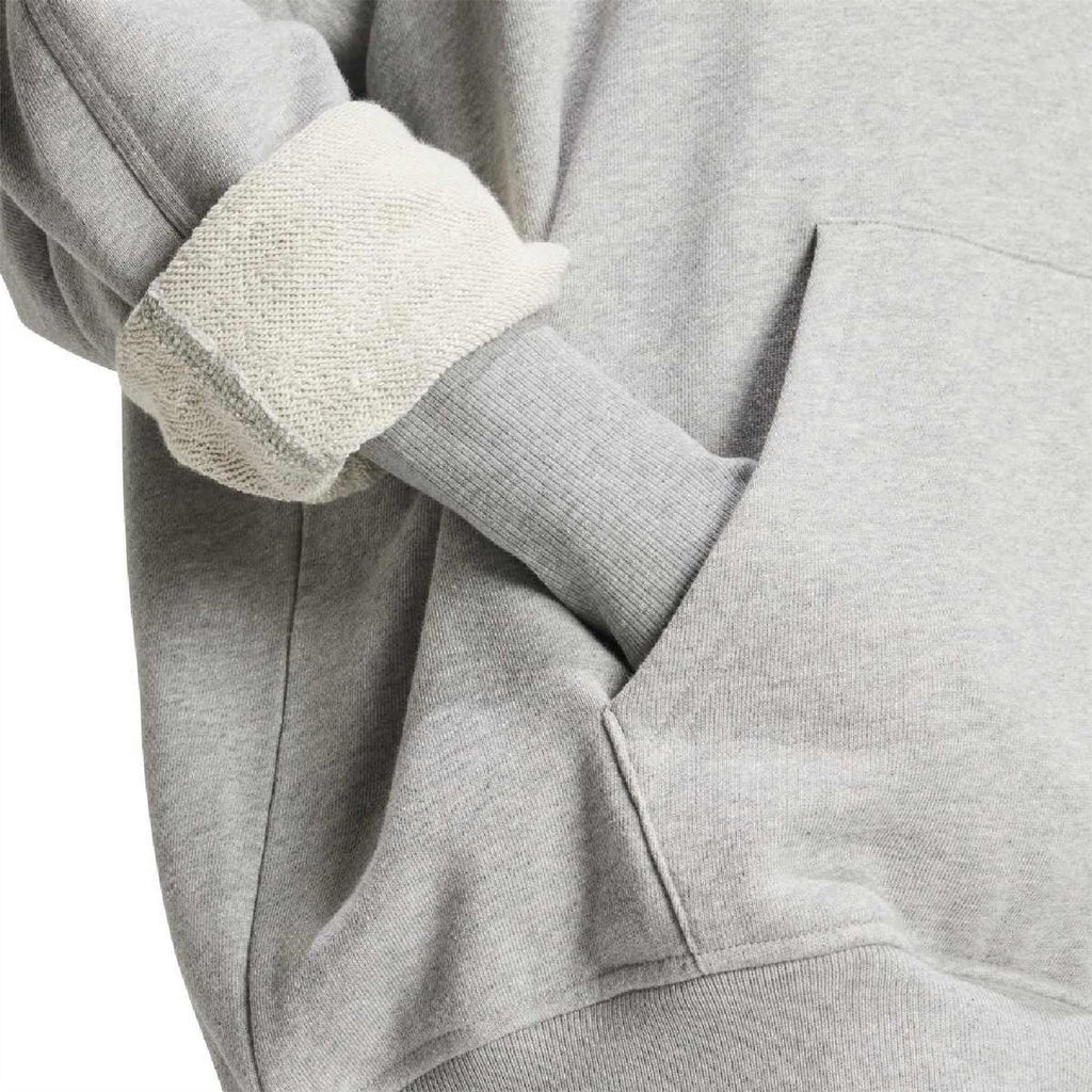 Light grey hoodie close-up: ribbed knit cuffs and kangaroo pocket panel
