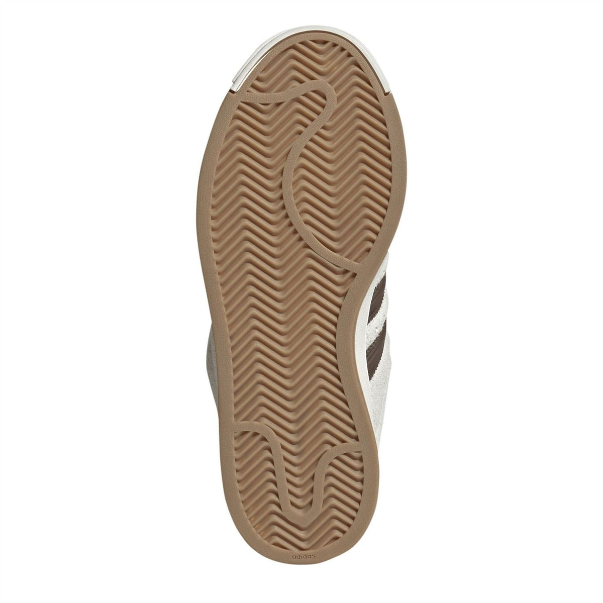 Underside outsole of off-white and brown sneakers with textured gum rubber tread pattern.