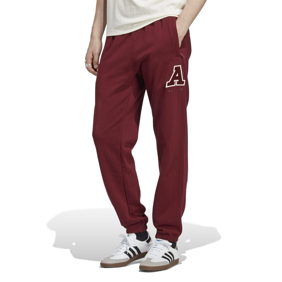 Burgundy track pants with front pockets and large A logo on right thigh