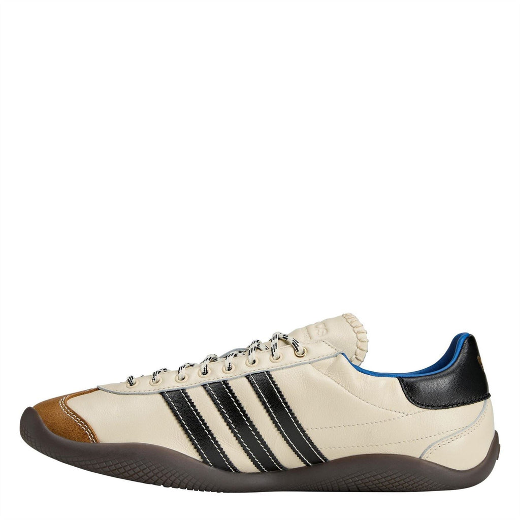 adidas Originals low-top sneakers, cream with black stripes, brown toe, and blue lining