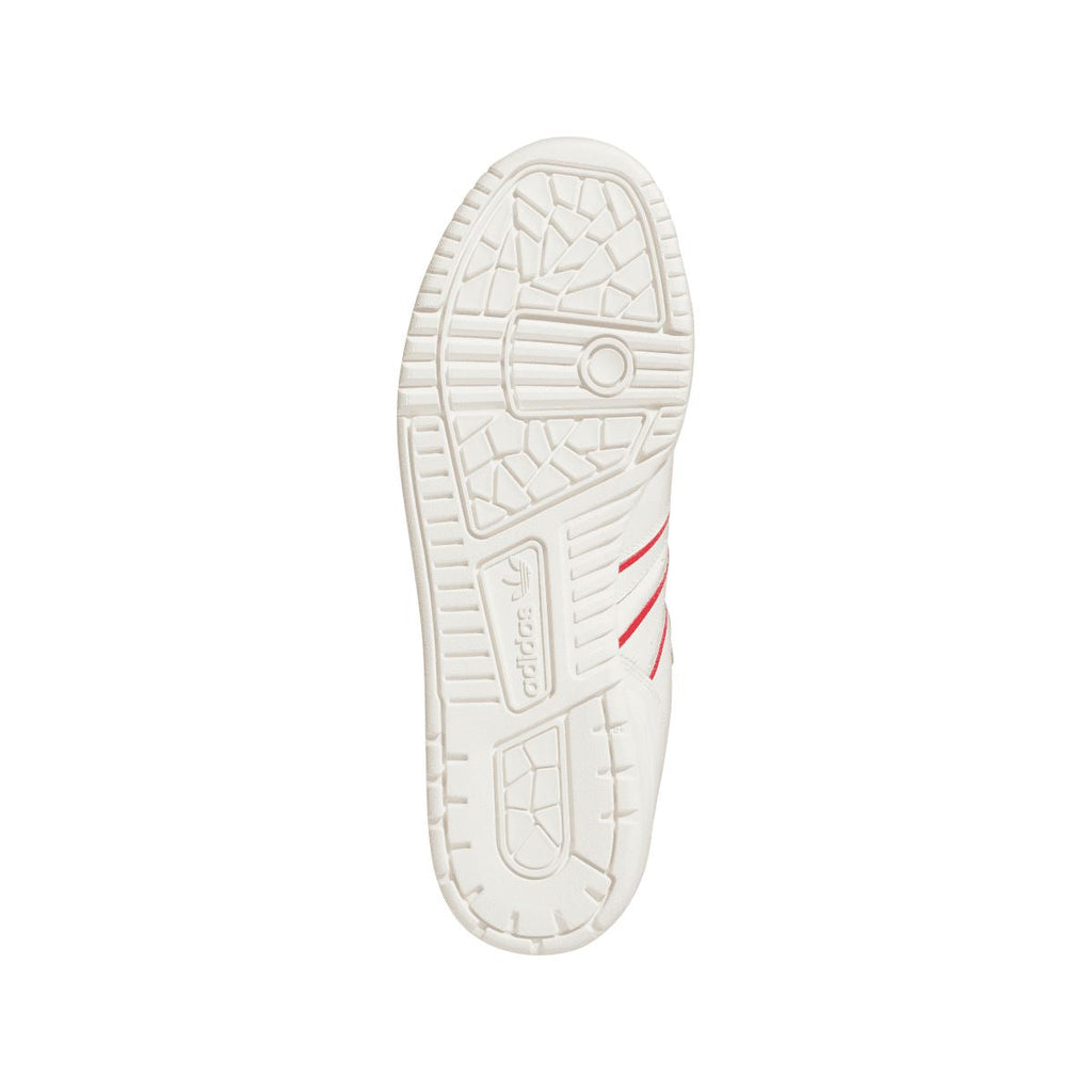 White rubber outsole with tread pattern and circular grip detail.