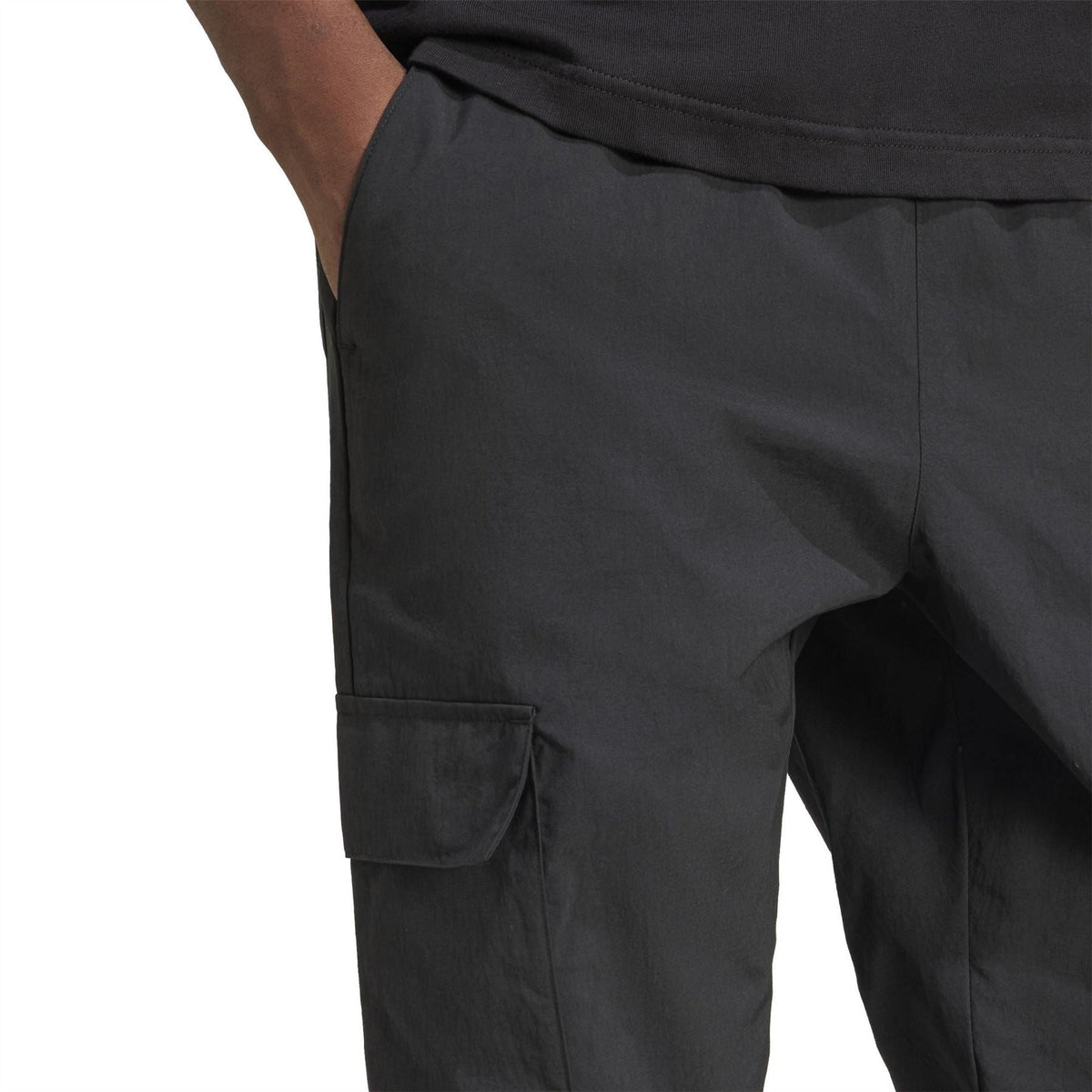 Black cargo pant leg with side flap pocket and elasticated waistband