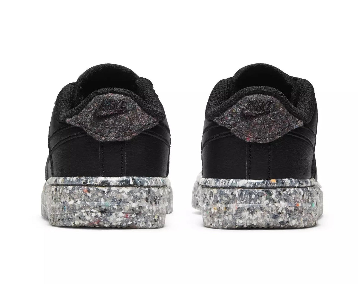 Toddler black sneakers with padded heel collar and speckled rubber platform sole