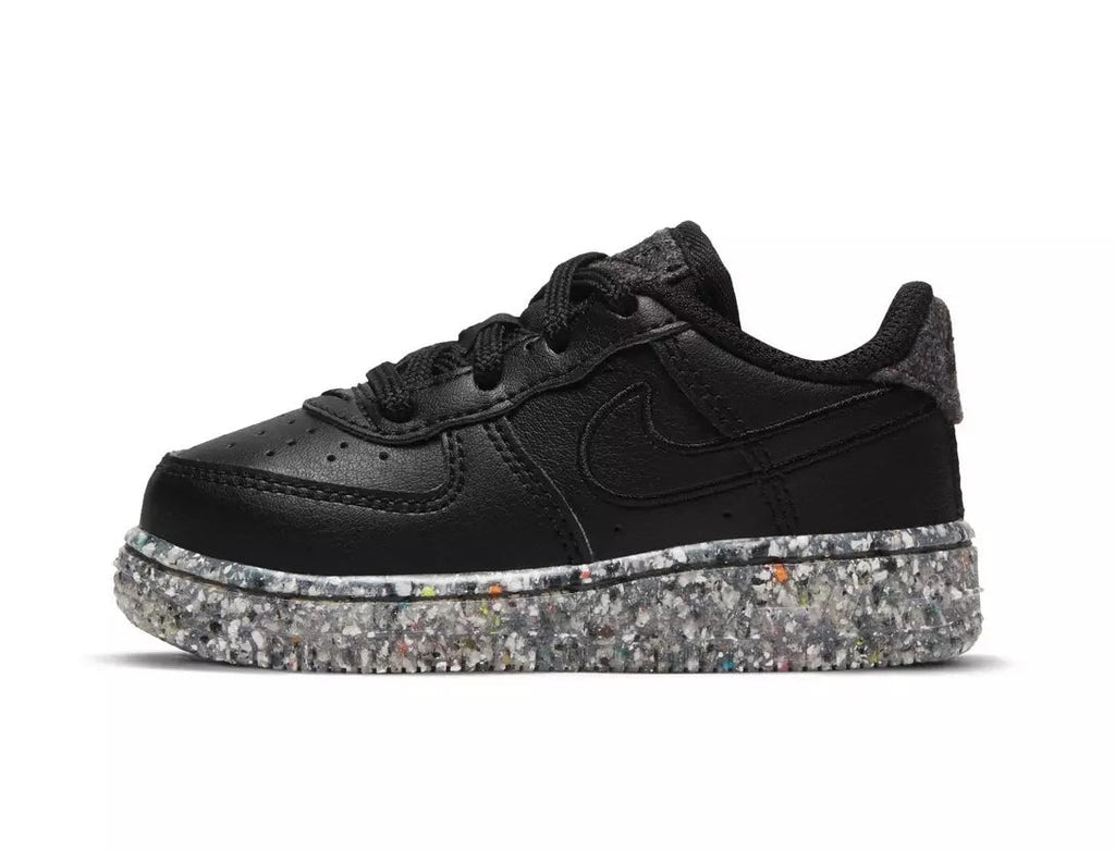 Toddler black low-top sneakers with Nike swoosh and speckled metallic-silver rubber sole