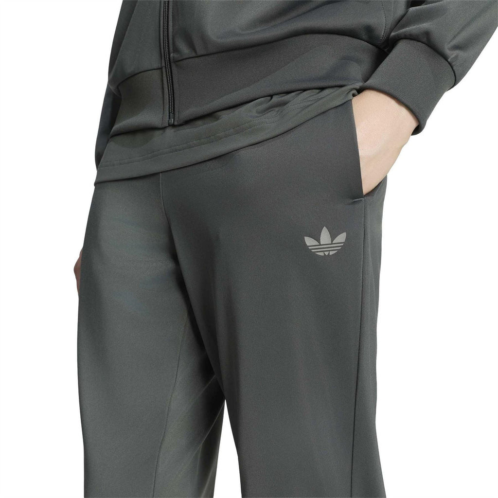 Close-up of dark green jogger pants with side logo and zippered jacket hem