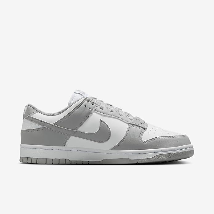 Low-top Nike Dunk Low sneaker with gray swoosh and white panels, lace-up.