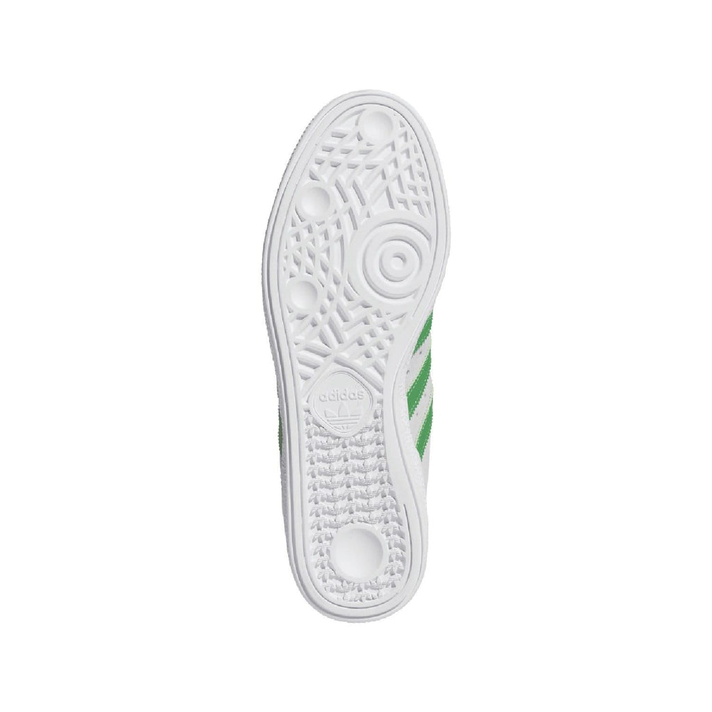 White rubber cupsole with textured tread and green stripe accent.