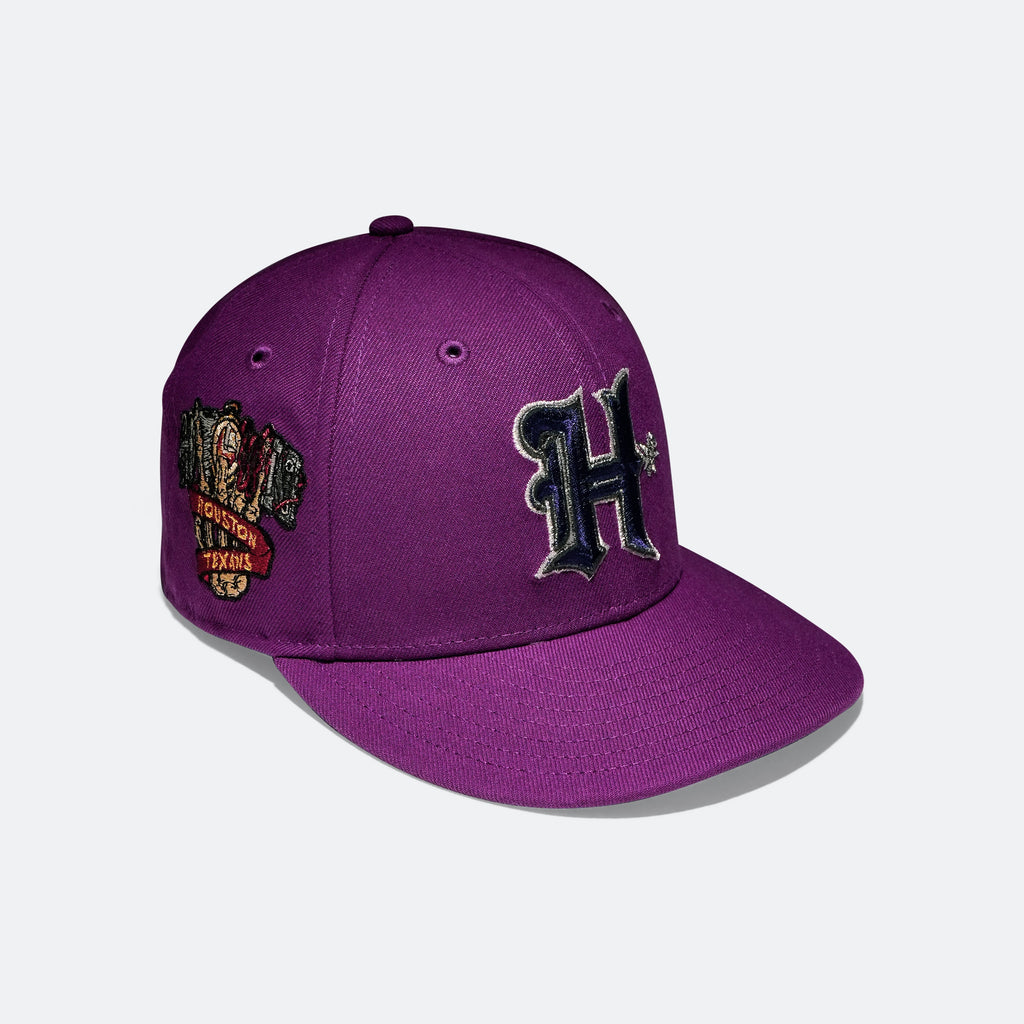 Purple baseball cap with side logo patches and an embroidered H on the front