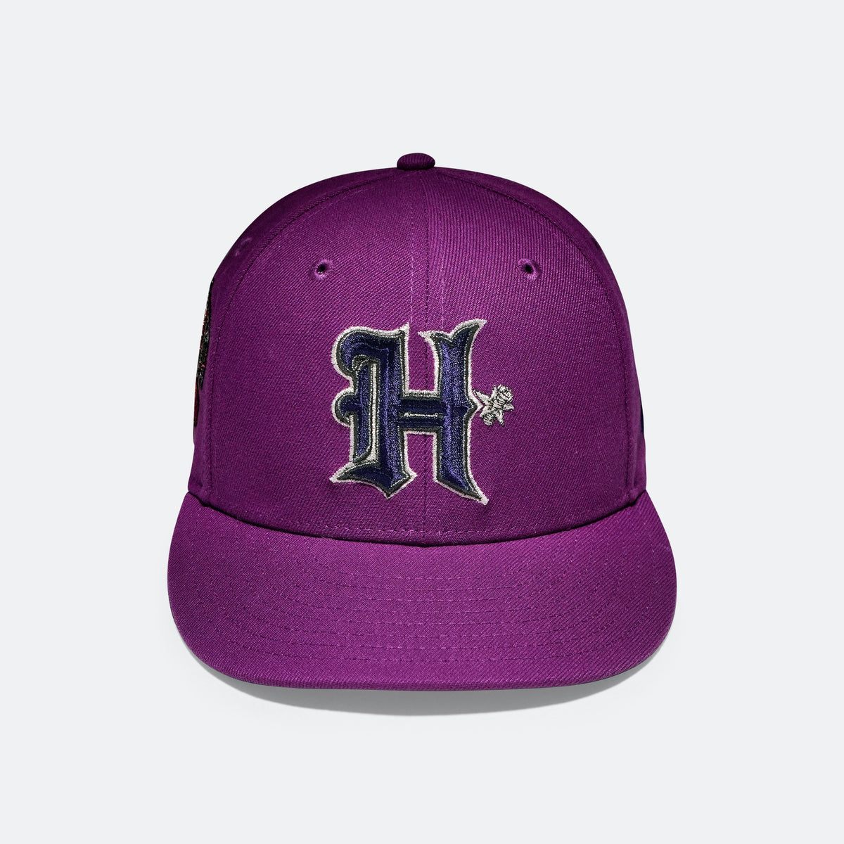 Purple baseball cap with embroidered H logo on the front panel