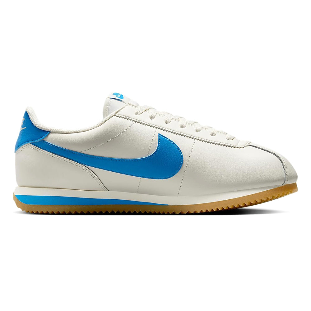 Nike low-top sneakers, side view in white leather with blue swoosh and gum sole