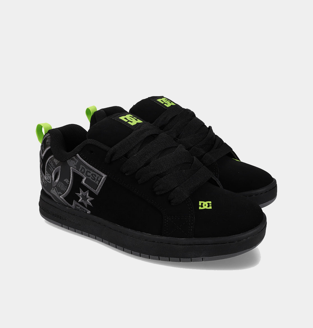 Black low-top sneakers with gray logo print and neon green side accents