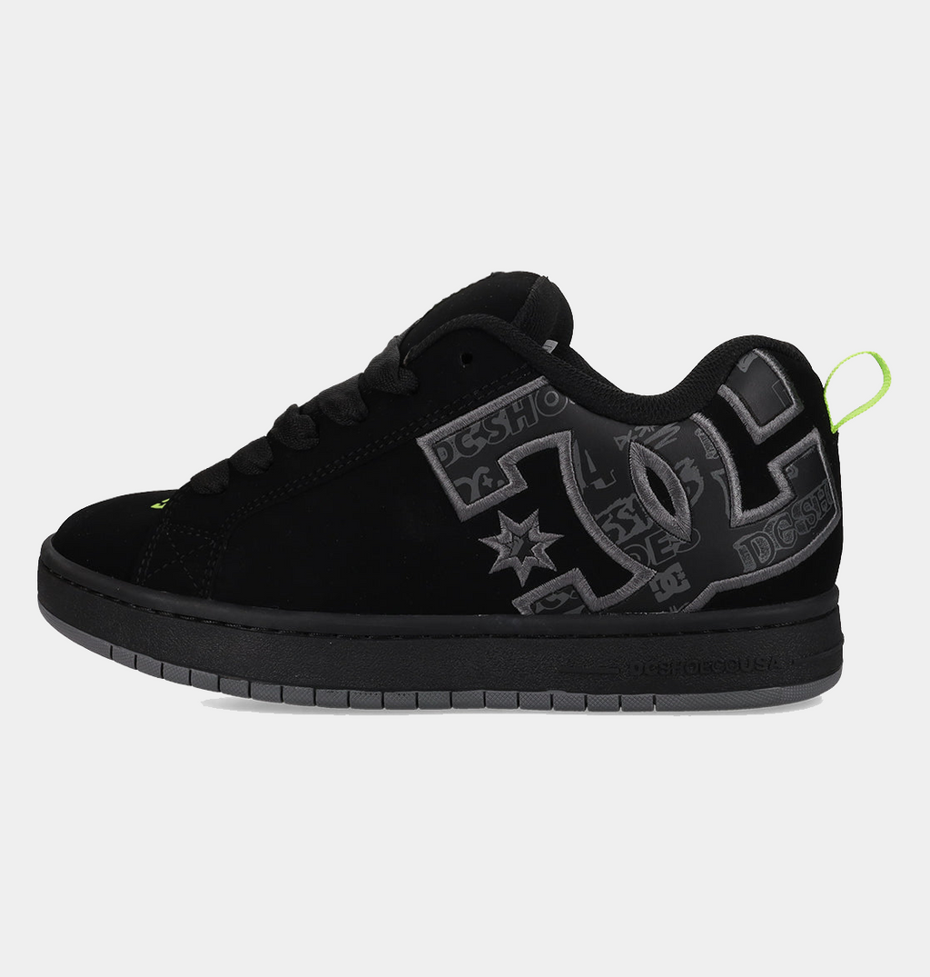 Black low-top sneakers with gray DC-style graphics and neon green heel detail
