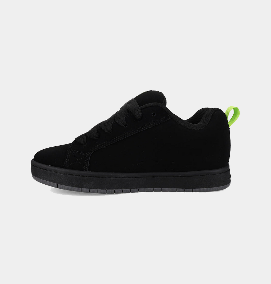 Black low-top sneakers with a green pull tab and clean front profile