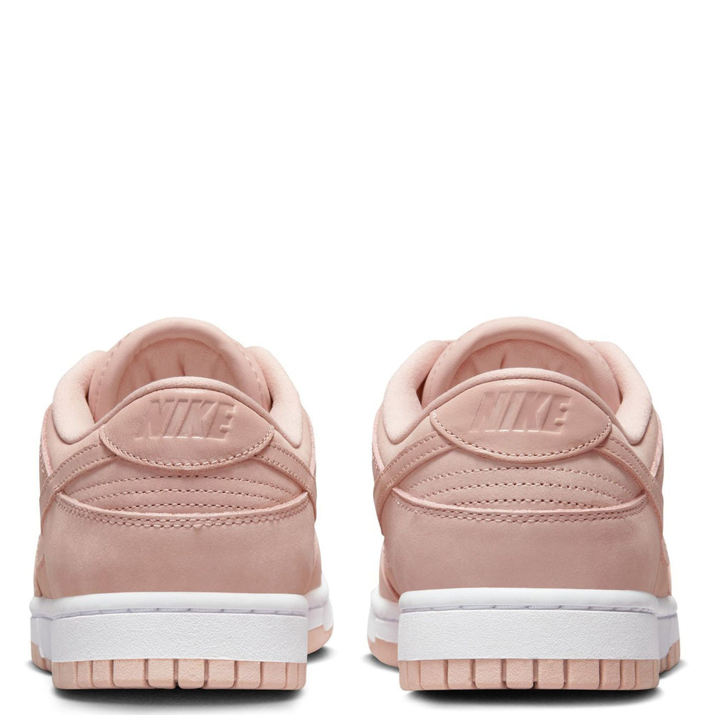 Pink Nike low-top sneakers, rear view with Nike heel logo and white sole