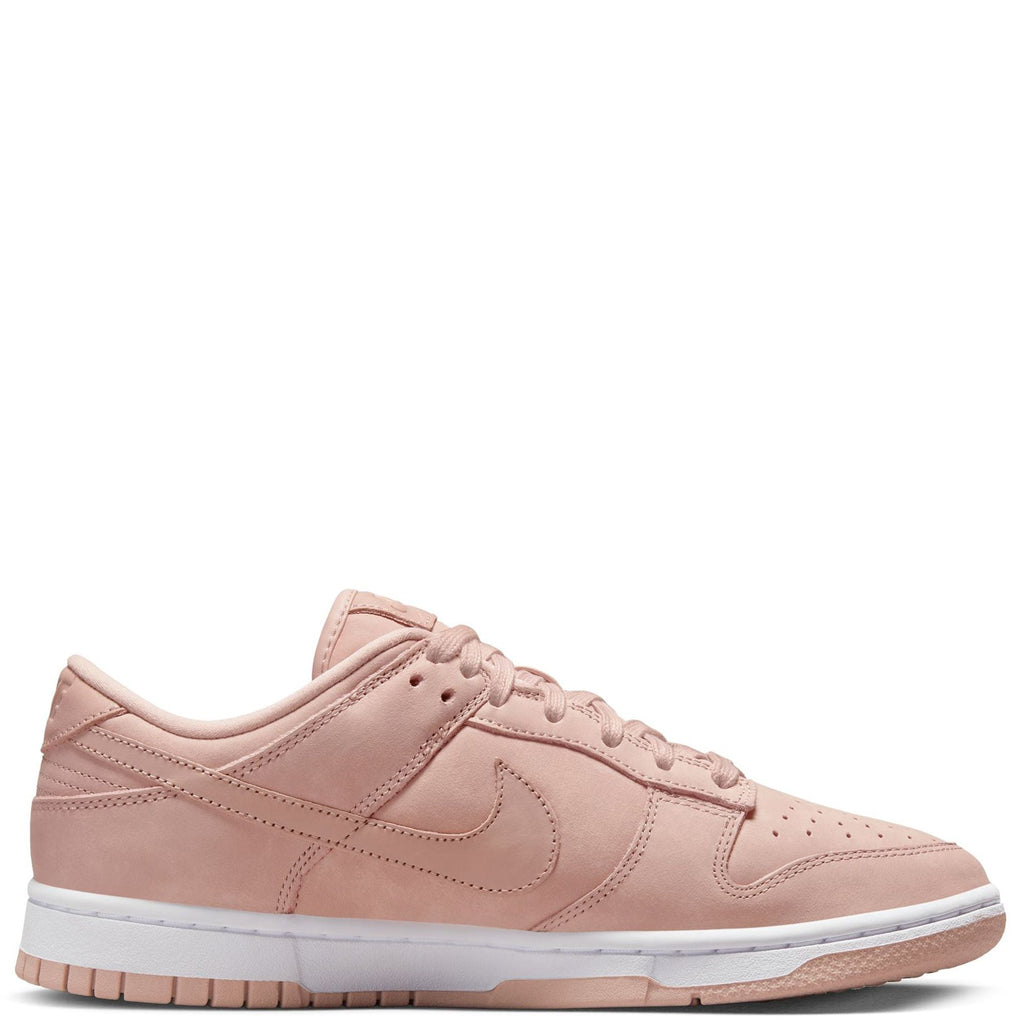 Pink Nike low-top sneakers, side profile with Swoosh and white midsole