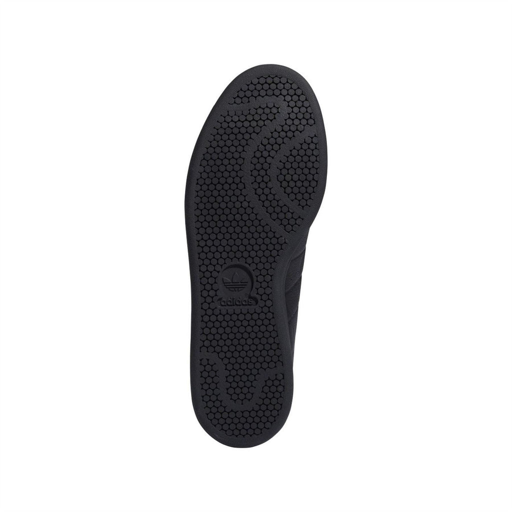 Black rubber outsole with hex tread pattern under the trainers