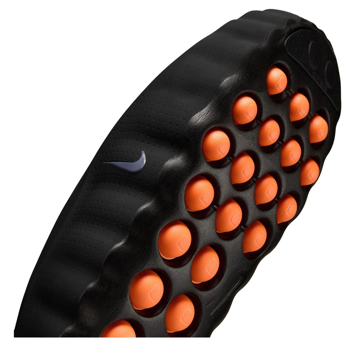 Black Nike slide sandals close-up, orange traction pods on textured rubber outsole