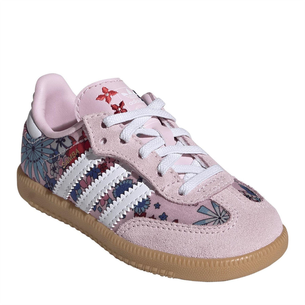 Pink low-top sneaker with white triple stripes, floral accents, and lace-up front.