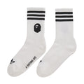 White crew socks with black top stripes and black Bape head logo