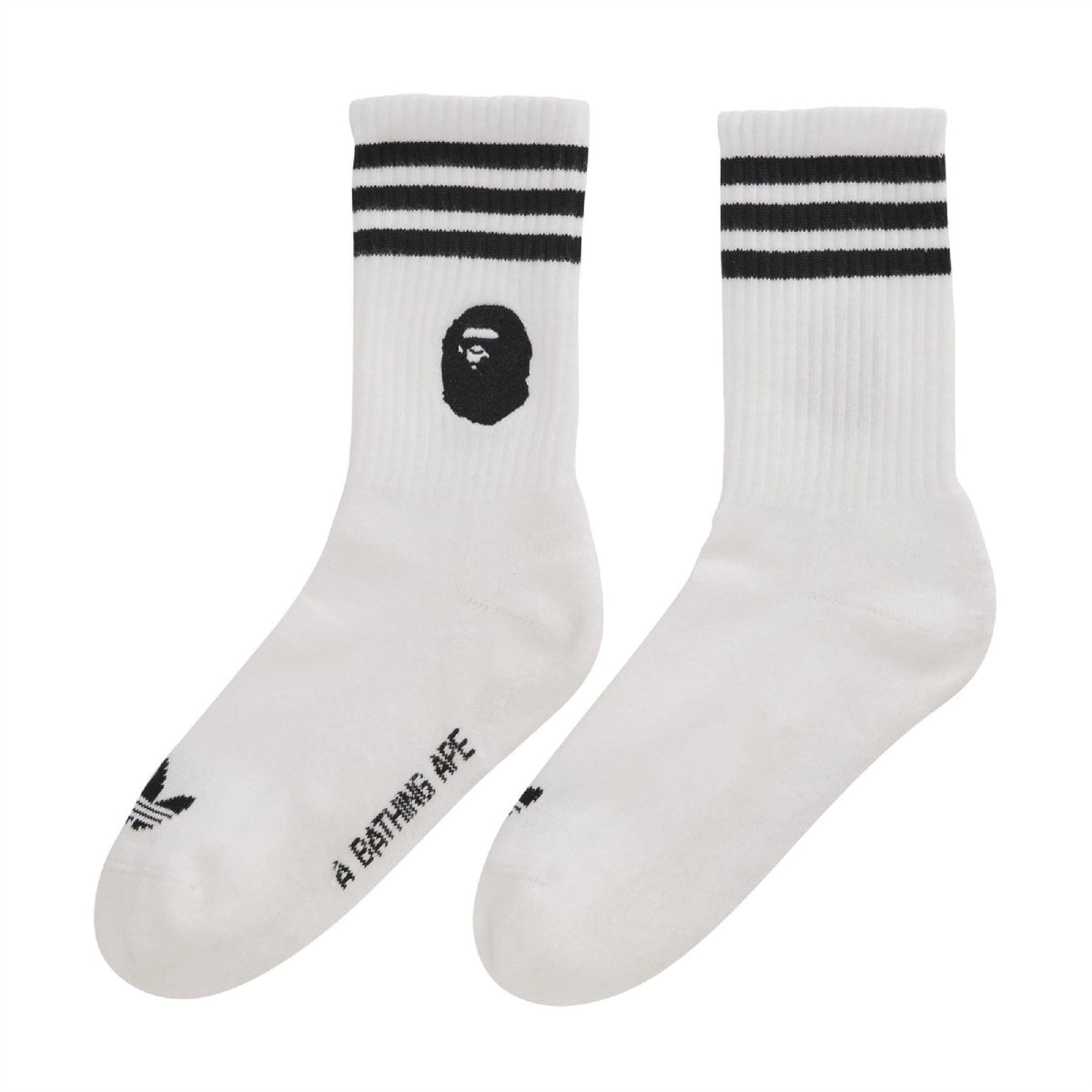 White crew socks with black top stripes and black Bape head logo
