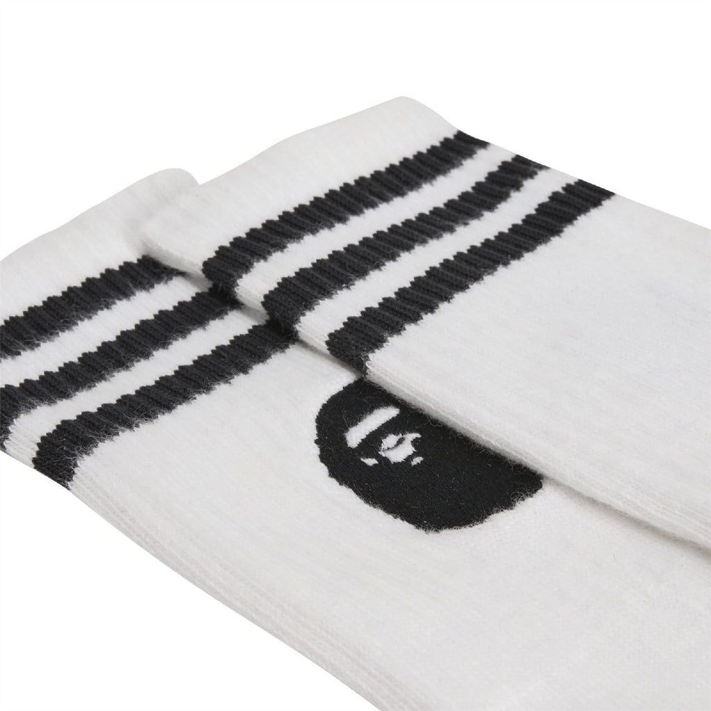 White crew socks with black three-bar stripes and black Bape head applique