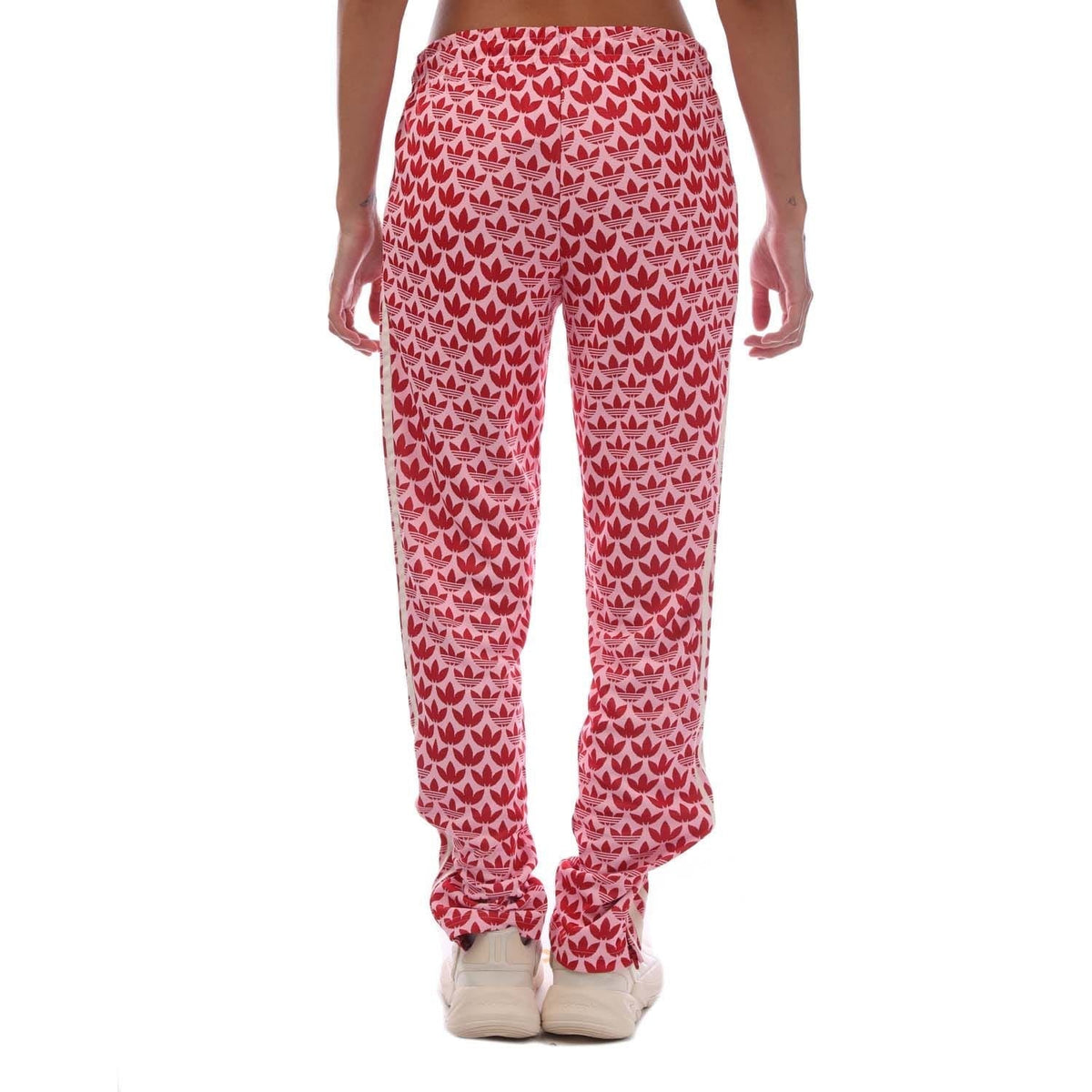 Pink track pants with repeating heart pattern, straight legs, elastic cuffs