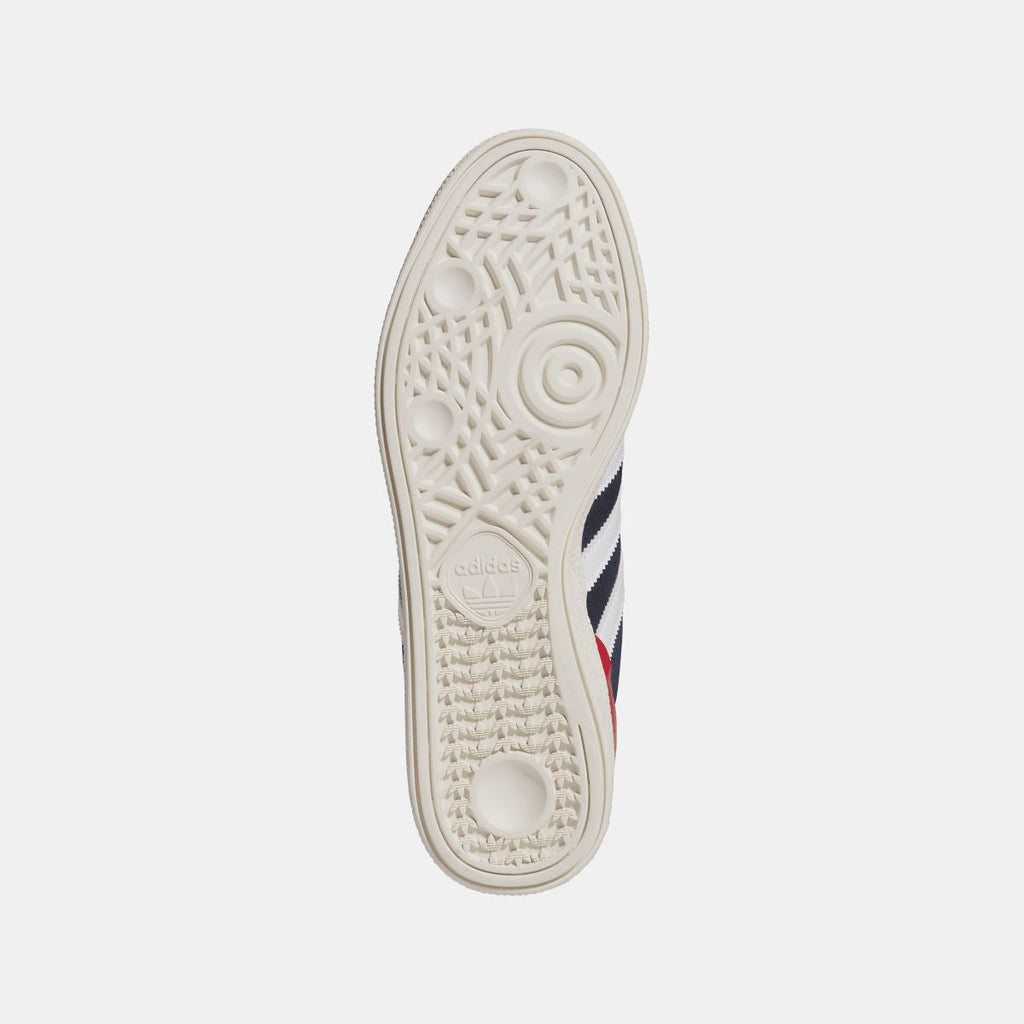 White outsole view of navy Busenitz sneakers with tread and adidas logo