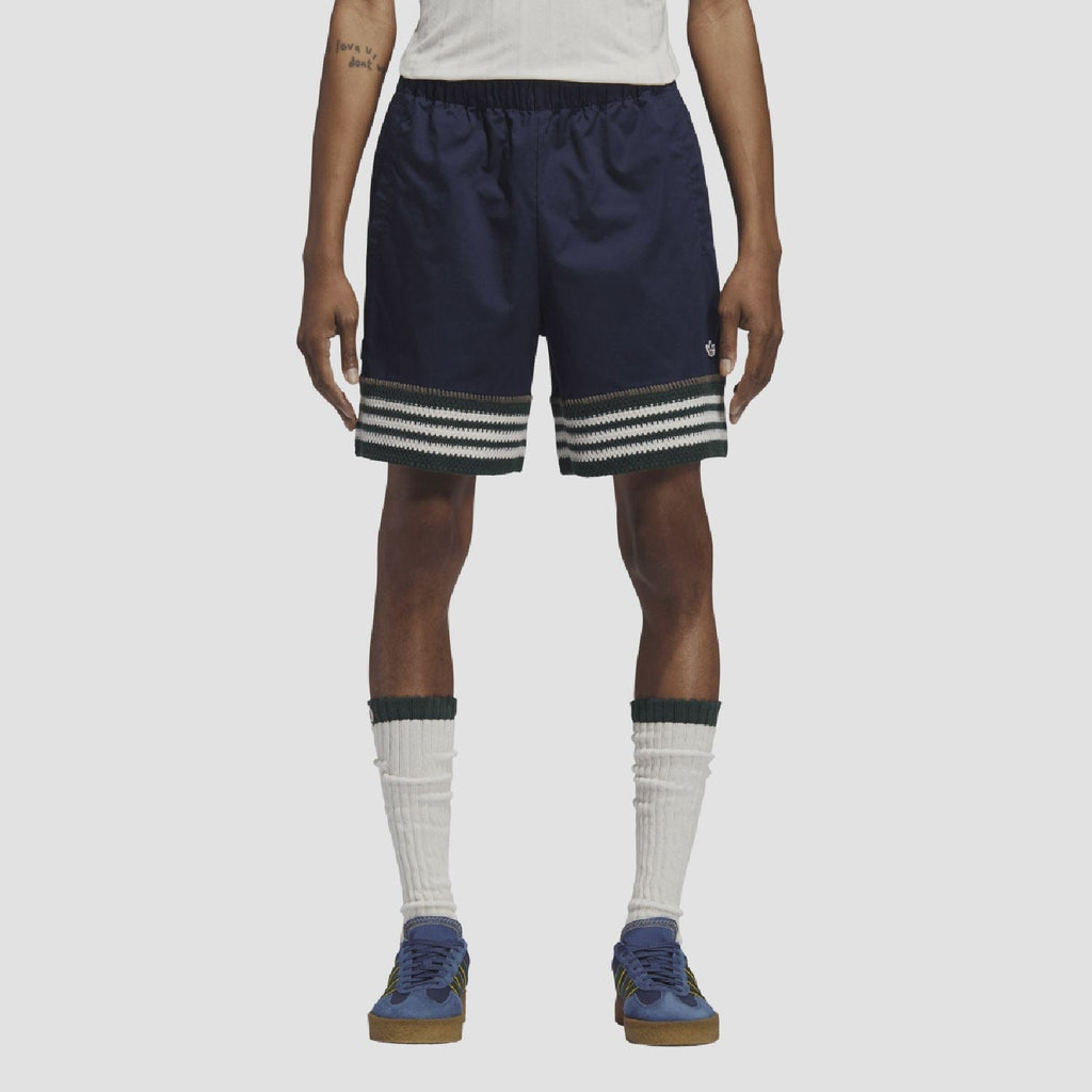 Indigo knit shorts on model, elastic waist and striped band at hem