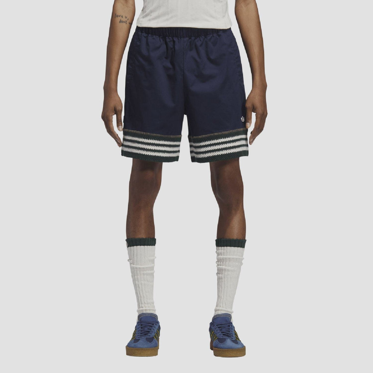 Indigo knit shorts on model, elastic waist and striped band at hem