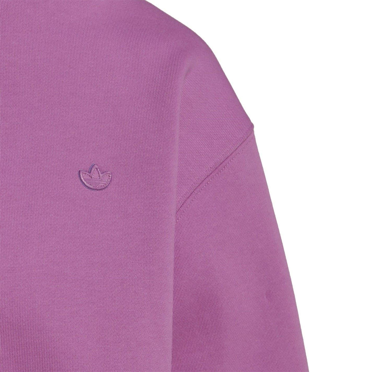 Purple crew sweatshirt side detail with small logo on sleeve and stitched seam.