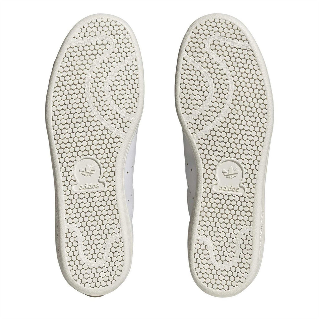Pair of white rubber outsoles with textured tread and adidas trefoil logo