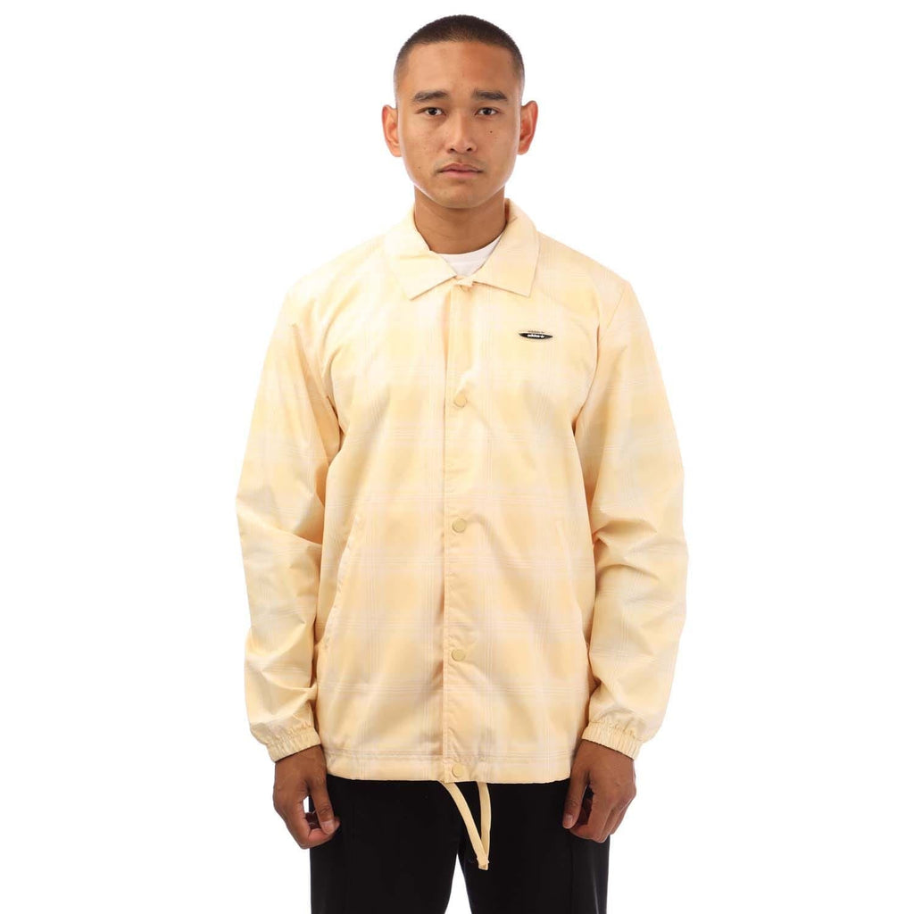 light yellow coach jacket with stand collar, button front, and elastic drawstring hem