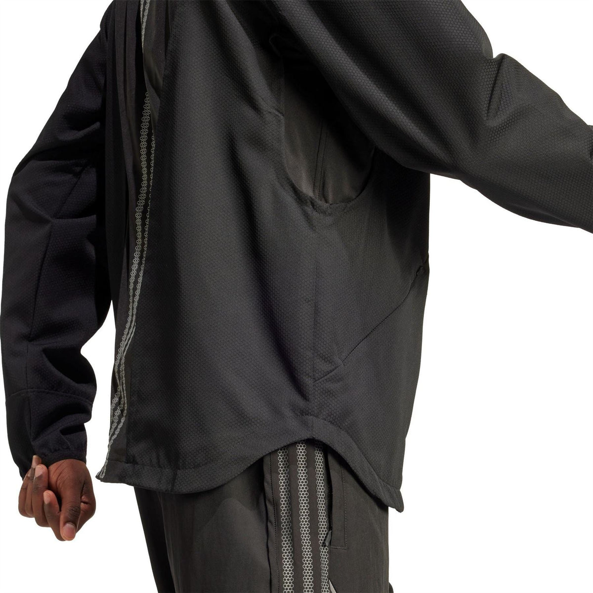 Black windbreaker jacket back detail with vertical vent stripe and mesh panels