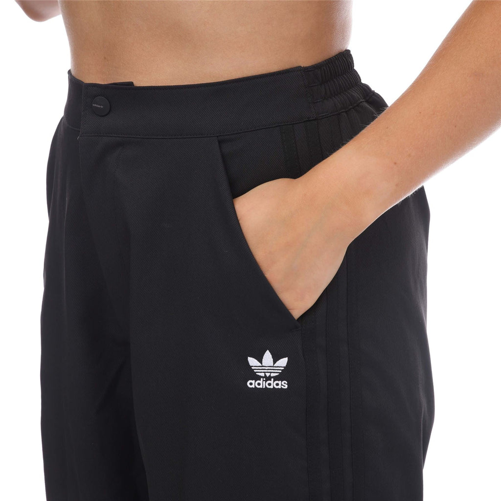 adidas Originals Adicolor Classic woven track pants in black with white side stripes, comfortable tapered fit, front pockets and elastic waistband