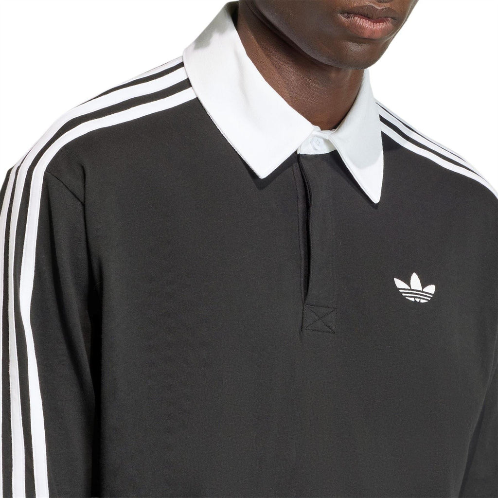 Black long-sleeve polo with white collar, adidas logo, and white shoulder stripes