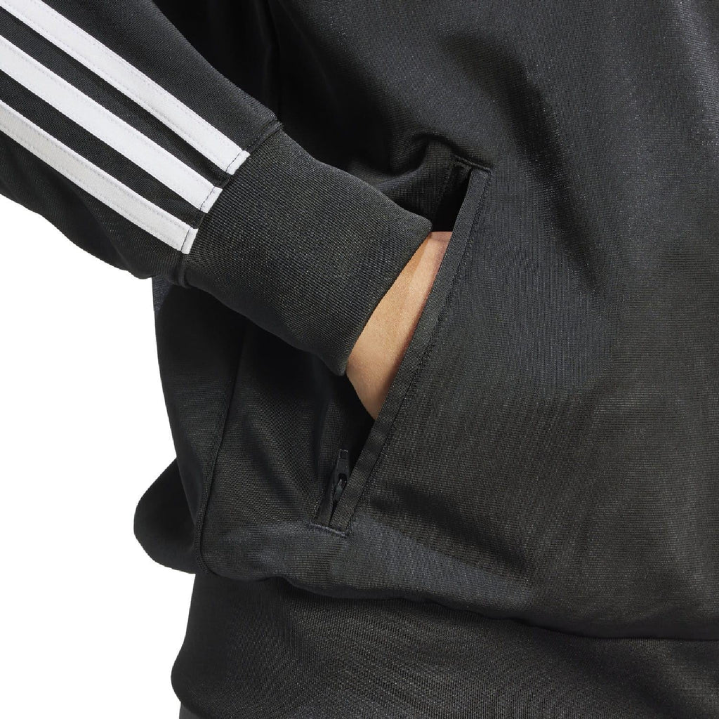 Black track jacket knit cuff and zipper close-up with white stripe band