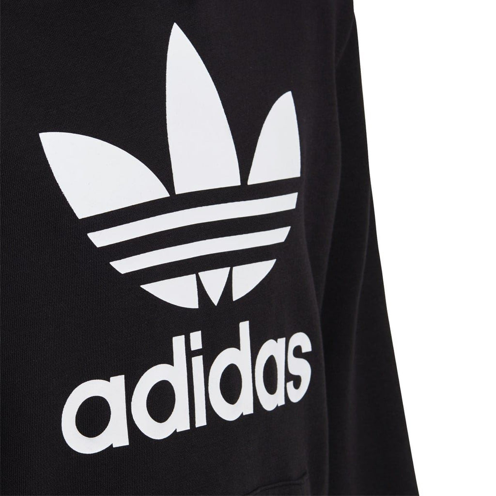 Black hoodie sleeve with large white adidas trefoil and adidas wordmark