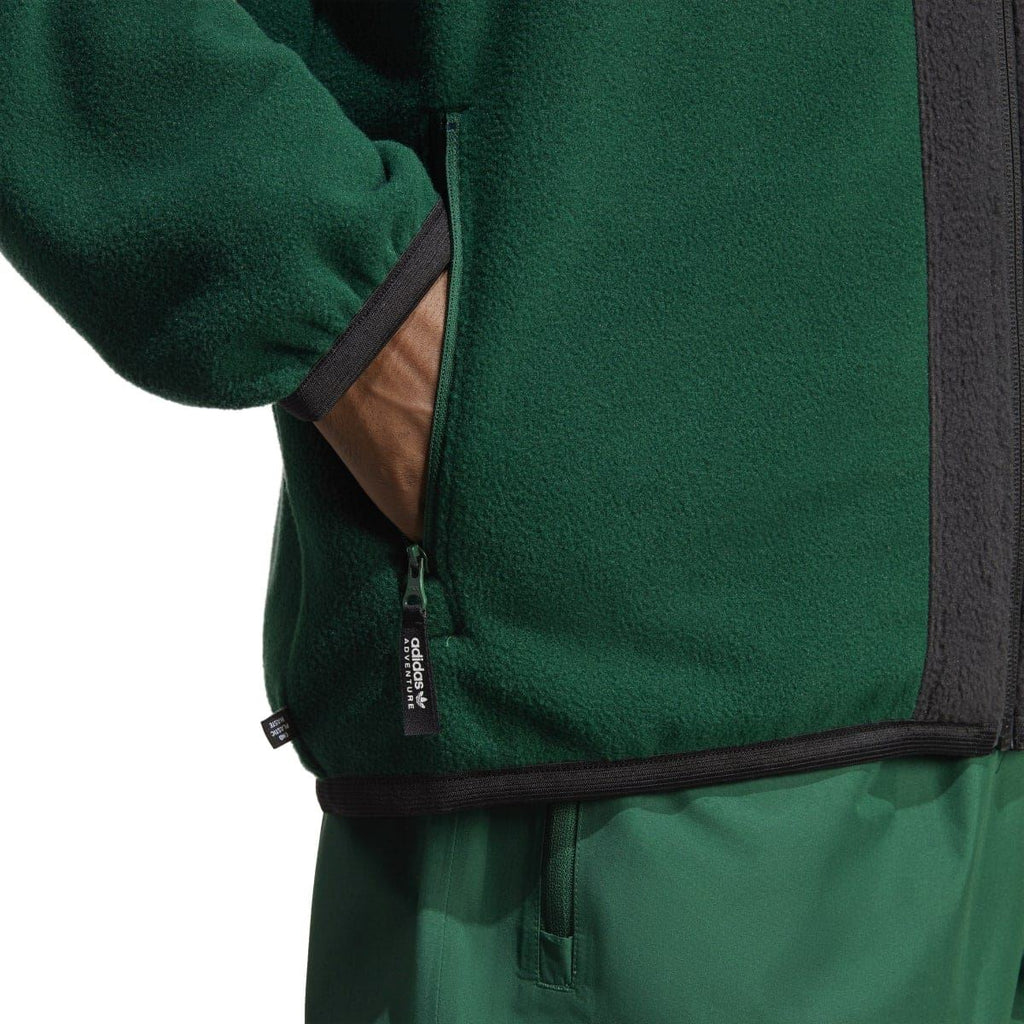 adidas hoodie sleeve and pocket area with black zipper trim and green fleece