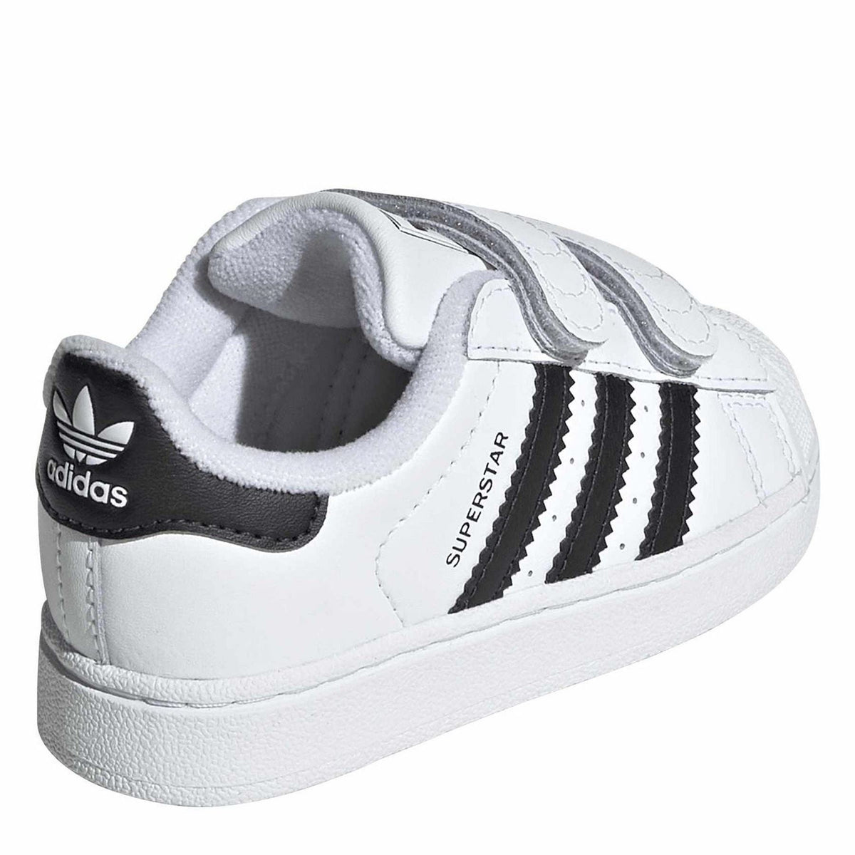 White leather sneakers with black heel collar, adidas logo, and black three stripe detail