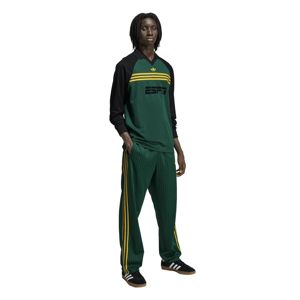 Adidas Originals Firebird track pants with gold emblem, dark green and yellow stripes