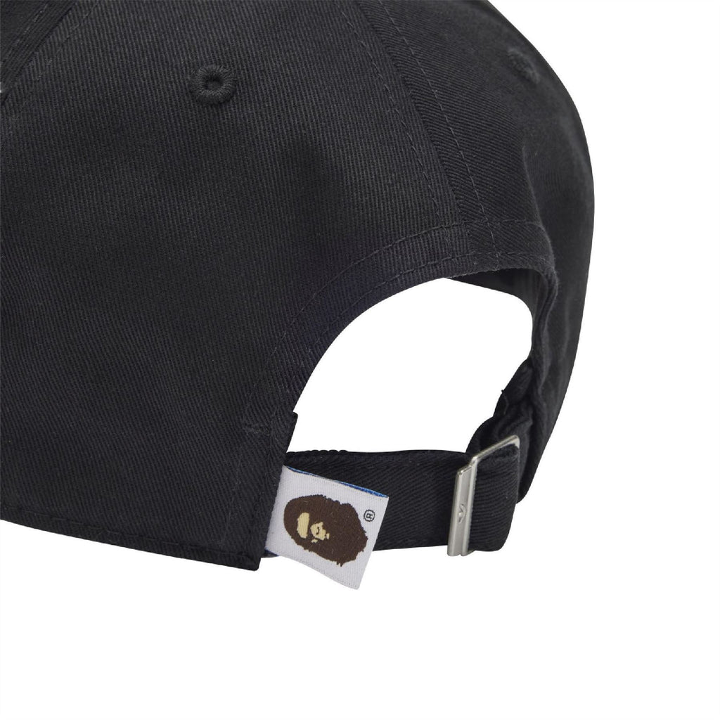 Black ball cap with adjustable metal buckle and interior brand tag