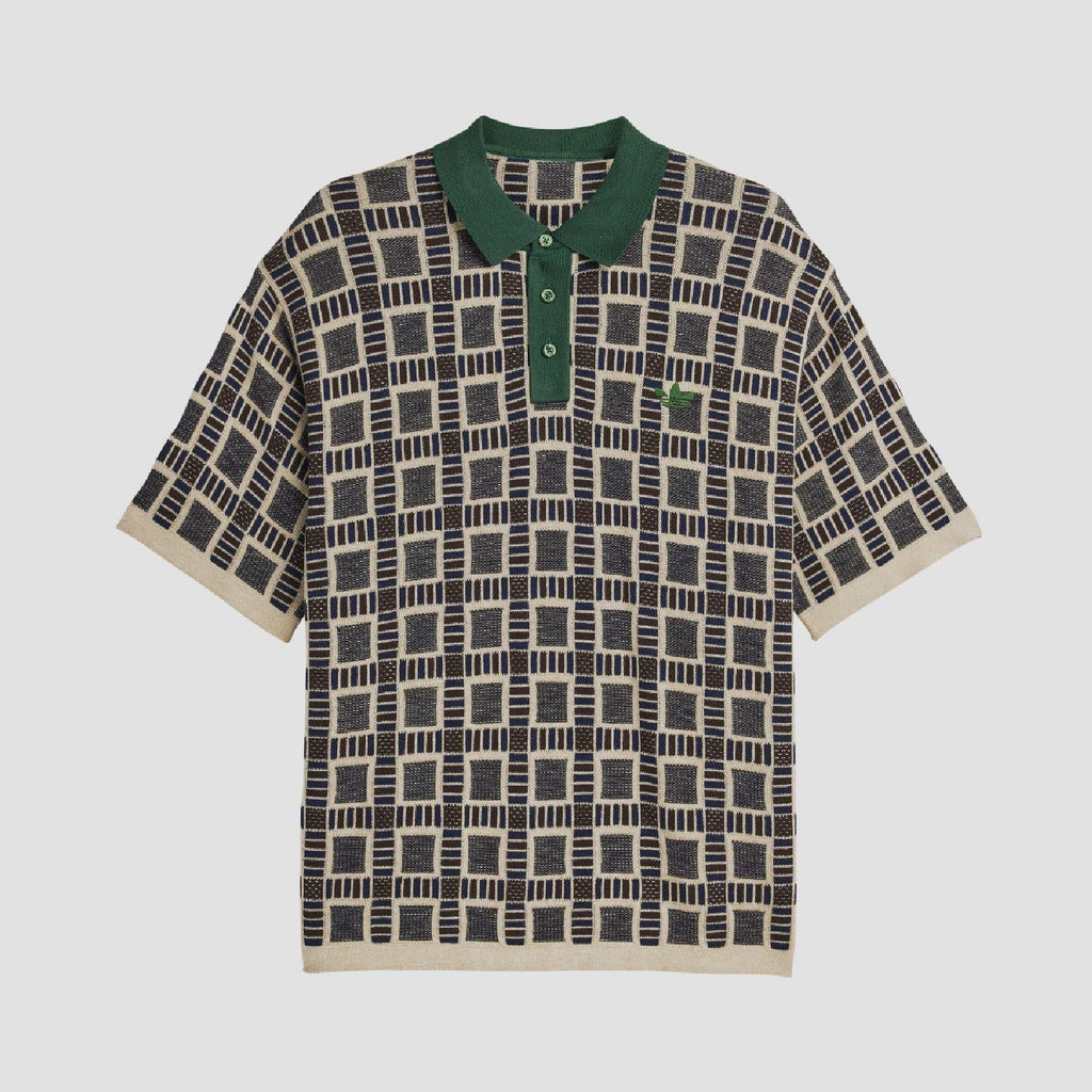 Front view of sand polo shirt; green collar and button placket with navy geometric grid.