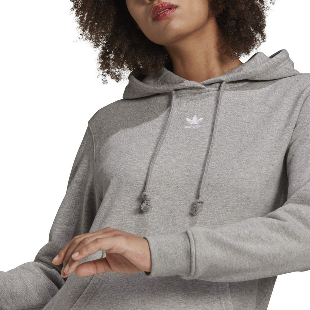 Grey heather hoodie close-up showing hood drawstrings and small chest logo